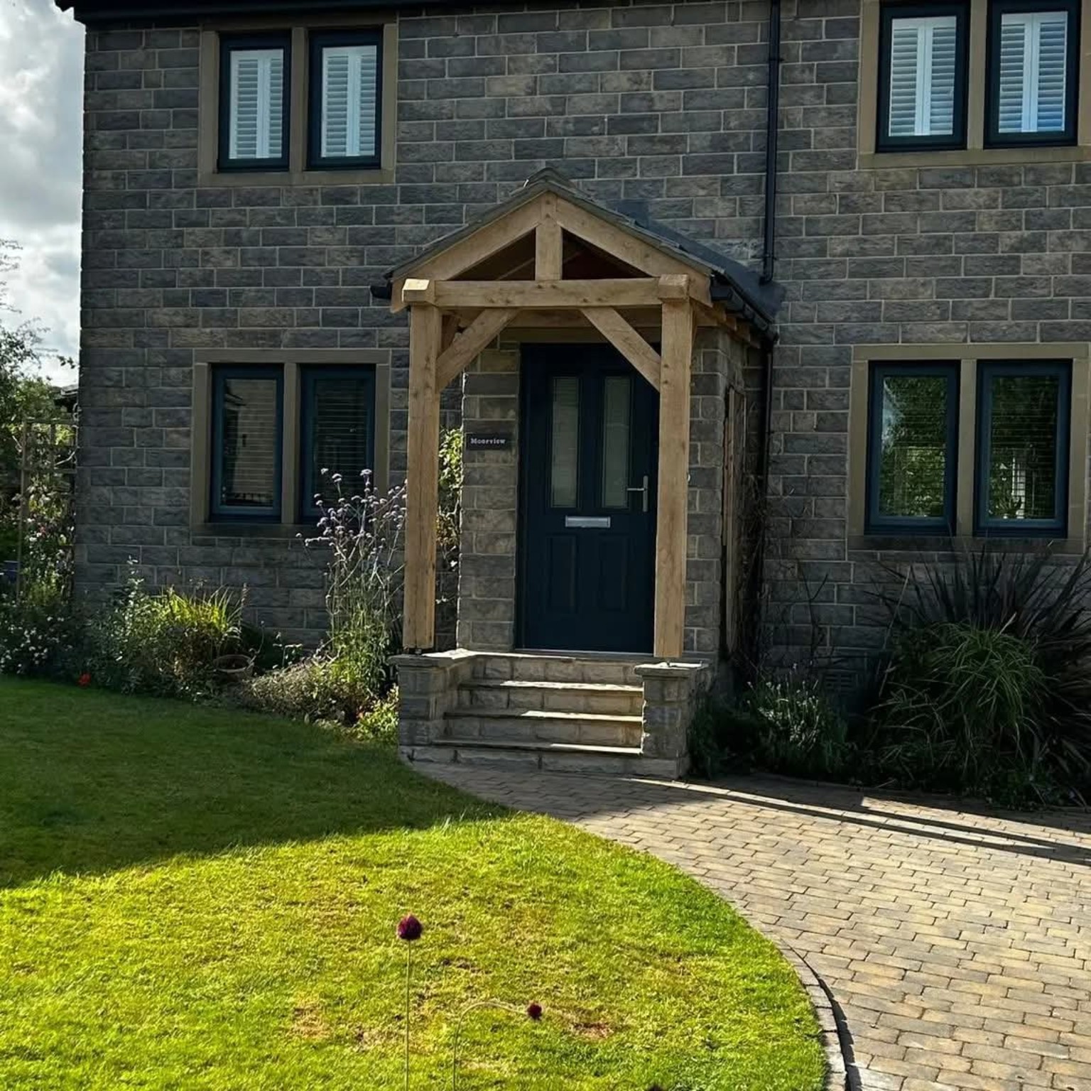 Handcrafted timber porch fitted to a stone house